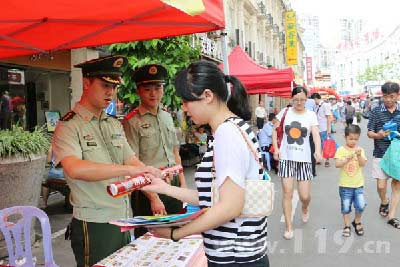 宣傳人員向過路群眾和游客發(fā)放宣傳小冊子